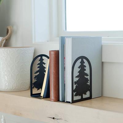 China Creative minimalist pine and cypress tree metal book rack iron cutting stationery book support frame book support partition for sale