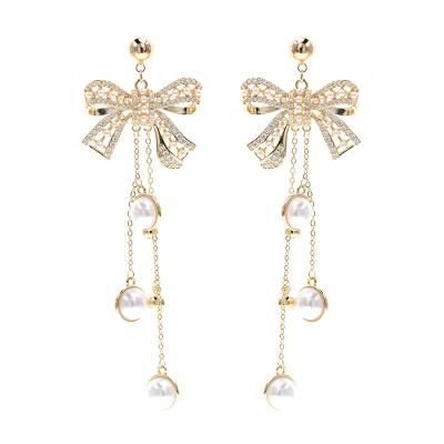 China Christmas Diamond Pearl Bow Earrings Jewelry 18K Gold Jewelry Christmas Bow Earrings Full Bow Romantic Rhinestone Earrings For Women for sale