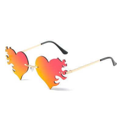 China Fashion Sunglasses 2022 Trendy Sunglasses Love Funny Mrror Sun Heart Eyewear Party Sunglasses Women Rimless Metal Colorful Glass for sale