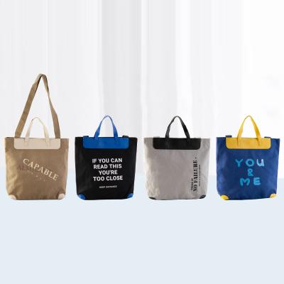 China Waterproof Portable Outdoor UWELD Shopping Bag The Single Schoolbag Letter Printed Canvas Handbag for sale