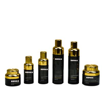 China 50g 100g 30ml 50ml 100ml 120ml Refillable Lotion Serum Container Gold-plated Threaded Lid Black Glass Bottle Jar Set for sale