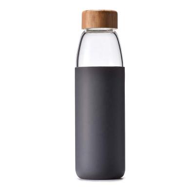 China Viable Custom Logo Free Wooden Bamboo Lid BPA Borosilicate Glass Drinking Water Bottle With Silicone Sleeve for sale