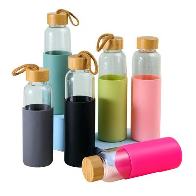 China Custom Colored Borosilicate Glass Sustainable BPA Free Drinking Water Bottle With Bamboo Lid for sale