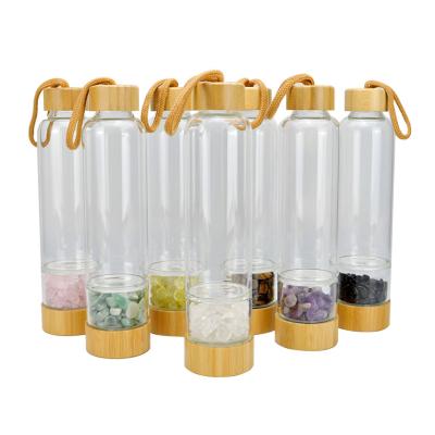 China Wholesale Natural Viable Gemstone Drink Healing Quartz Stones Infused Glass Energy Crystal Water Bottle With Bamboo Lid for sale