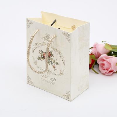 China Custom Made Luxury Recycled Materials Clean Logo Printed Wedding Gift Packaging Paper Bag Retail Clothing Shopping for sale