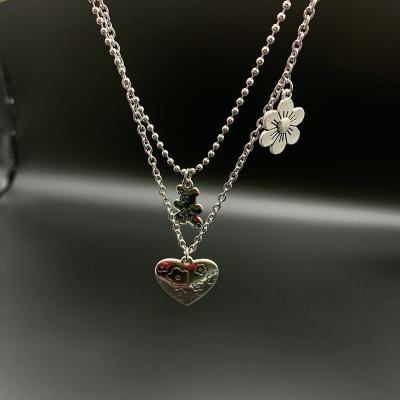 China DIY Jewelry Accessory Couples Love Flower Bear Letter Pendant Retro Bounced Wind Necklace Set Stainless Chain for sale