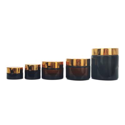 China Eco - Friendly 10g 15g 30g 50g 100g 200g Amber Brown Cosmetics Prepare Glass Jar With Gold Lid for sale