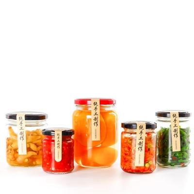 China Factory price canned food 50ml-1000ml round storage glass jars for honey with lid for sale