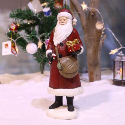 China Europe Christmas Decoration Crafts Resin Santa Collectibles Holding Gift Santa Claus Figurines for sale