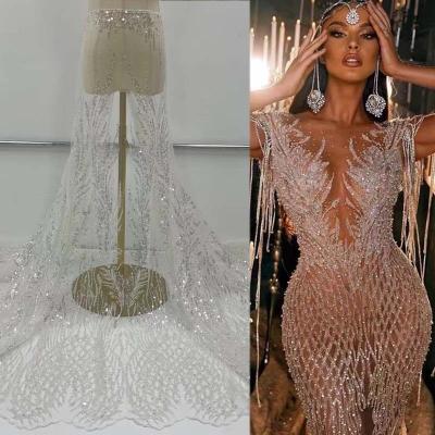 China luxury wedding bridal 3D sequins embroidery pearls white tulle beaded lace fabric for wedding dress party dress for sale