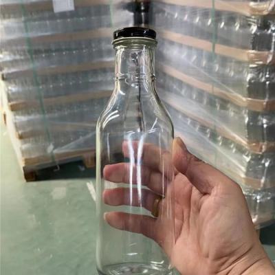 China Chinese Beer Bottle Supplier Beverage Liquor Clear Glass Drink Bottles With Cap for sale