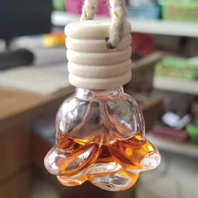 China Personal Care 6ml Perfume Sub-pack Glass Bottle Empty Portable Car Pendant Rose Shape Bottles Like Gift for sale