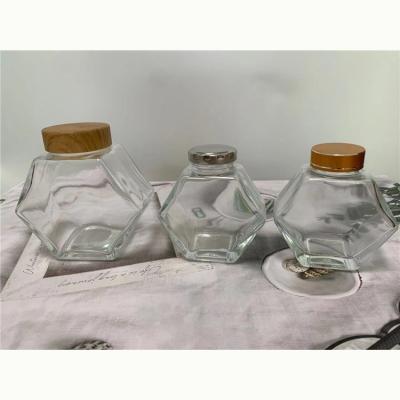 China Sustainable Gold Plus Supplier Tansparency Bottle Hexagon Honey Glass Jar for sale