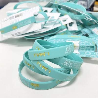 China Eco Friendly Cheap Custom Rubber Wristbands Light Blue Silicone Wristband With Paper Card for sale