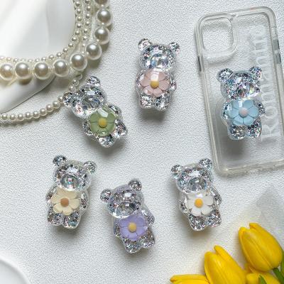 China Customized Adjustable Color Transparent Cartoon Cell Phone Holder 3D Resin Bear With Flower Phone Grip Phone Stand Holder Plug for sale