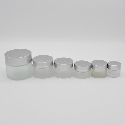 China Modern And Simple Cosmetic Round Matte With Clear Cover Glass Bottle Jar Cosmetic for sale