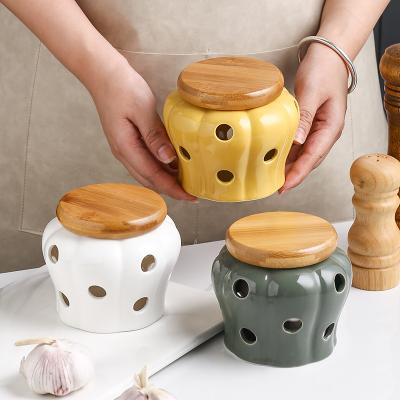 China Sustainable Ceramic Garlic Ginger Jar with Wooden Lid Refined Storage Tank Candle Jars Porcelain Storage Container for sale