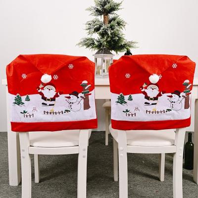 China Indoor Santa Claus Red Hat Christmas Chair Snowflake Cover Christmas Dining Table Decoration Christmas Banquet Kitchen Decor for sale