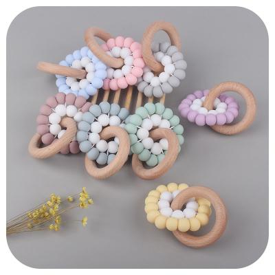 China Soft Silicone BPA Free Baby Grade Toy Silicone Teeth Chain Food Chewing Gum Teethers and Beech Wood Ring Teething Toys for sale