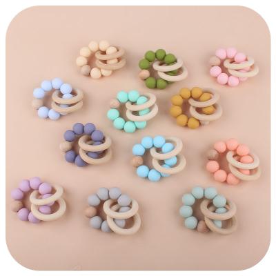 China Wholesale Natural Eco-friendly Wooden Baby Toys Beads Ring Baby Rattle Teether 15MM Silicone Animal Bracelet for sale