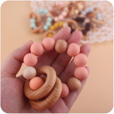 China Natural Eco-Friendly Wooden Organic Rattle Toy Teething Silicone Teether Chew Food Grade Baby Bracelet for sale