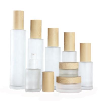 China Oi Essential Empty Glass Cosmetic Packaging Sets Clear Frosted Cream Jar With Bamboo Pattern Lid Glass Bottle For Toner Lotion for sale