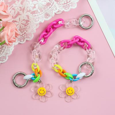 China Fashionable Face Plastic Acrylic Smilling Female Assemble Chain Earphone Cover Device Pendant Flower Key Chain for sale