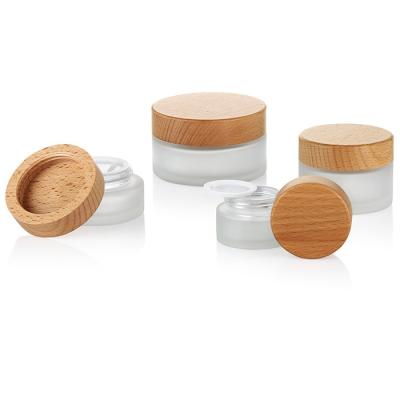 China Beautiful Full Empty Organic Bamboo Cosmetic Jar 15g 30g 50g 100g 100% Bamboo Cap Packaging Glass Jars With PP Coating for sale