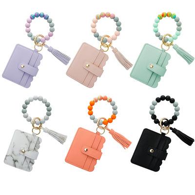 China Hot Leather Beaded Tassel Wristband Holder Credit Card Pocket Wristband Keychain Key Ring Holder Silicone Souvenir Gifts Promotion Sale Key Chain Wallet For Women Men for sale