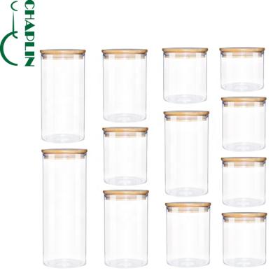 China Sealed Microwavable Cylinder Air Tight Kitchen Jar Glass Container With Bamboo Lid For Storage for sale