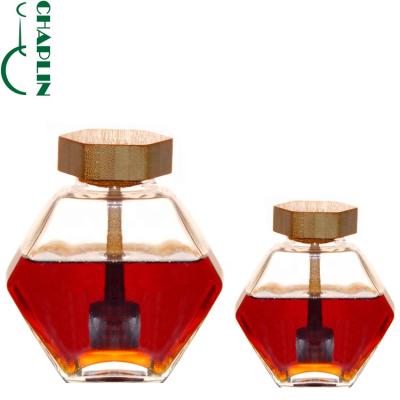 China Hexagonal Wood Cover High Grade Microwavable Honey Jar With Stirring Rod Glass Jars For Honey for sale