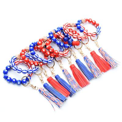 China 2022 New USA Flag Star Pentagon Bead Bracelet Simple Patriotic Wooden Leather Tassel Bracelet Main Chain For 4th Of July Independence Day Gifts for sale