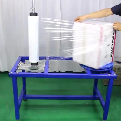 China Semi-automatic Food Stretch Wrapping Machine Plastic Film Roll Dispenser For Carton Packing for sale