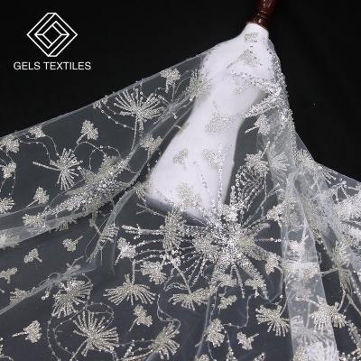 China New Wholesale Breathable White Pearl Embroidered Tulle Throw Gold Sequin Textile Fabric Breathable White Beaded Lace For Wedding for sale