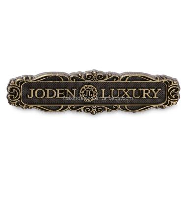 China Custom Europe Antique Embossed Die Casting Metal Logo Label for sale