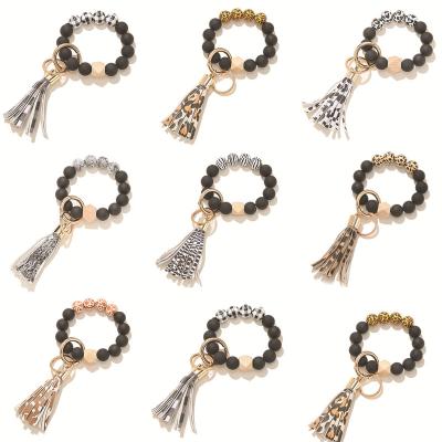 China Hot Selling Amazon Gift Promotional Souvenir Women Fashion Tassel Keychain Leopard Key Chain Bracelet Wood Bead Key Chain Bracelet for sale