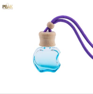 China Wholesale Cosmetic 5ml Empty Apple Shaped Air Freshener Empty Bottle Cap Wooden Hanging Car Perfume Bottle for sale