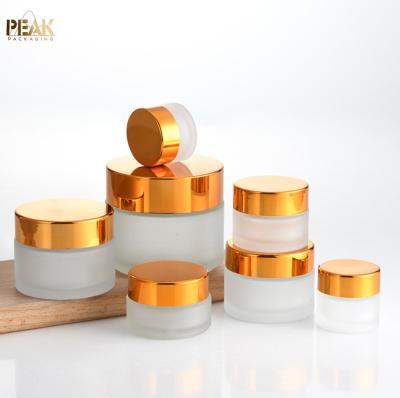 China 100g 30g 10g 50ml 1oz Small Bottle Facial Cosmetic Cream White Black Gold 50g Round Empty Clear Frosted Cosmetic Cream Glass Jar for sale