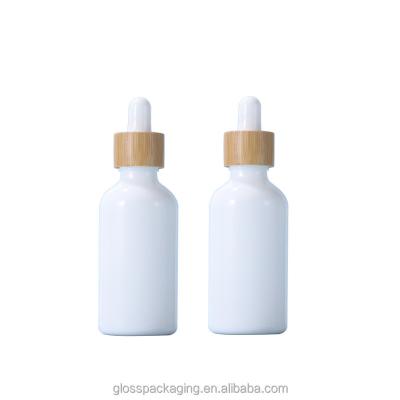 China Cosmetic wholesale glass gold circle child-proof cap essence skin care oil spiral mouth bottles with frosted white dropper bottles for sale