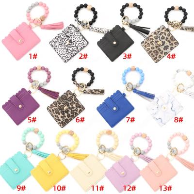 China 2021 Newest Daily Life Silicone Key Chain Pearl Bracelet Tassel PU Key Chain Luxury Card Holder Wallet For Women for sale