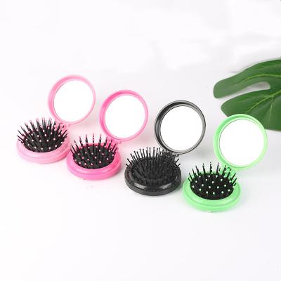 China Portable Foldable Travel Pocket Round Hair Brush Comb With Mirror Plastic Airbag Massage Comb for sale