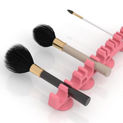 China Bathroom Desktop Wall Brush Holder Most Convenient Cosmetic Holder Bathroom Silicone Storage Makeup Brush Holder With Sucker for sale