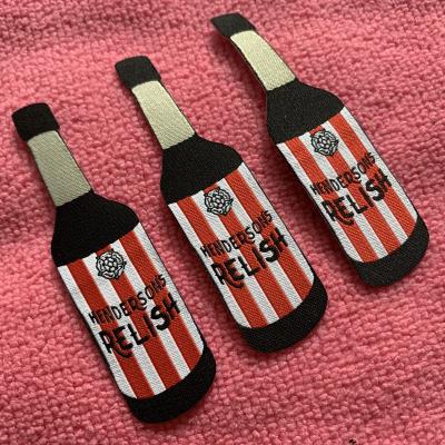 China Sustainable Laser Cut Bottle Shape Iron On Backing Clothing Label , Fashion Design Heat Press Woven Label For Baby Clothing for sale