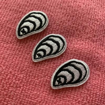 China 3D shell shape iron on embroidery labels for baby clothing, 100% full embroidery label for t-shirt for sale