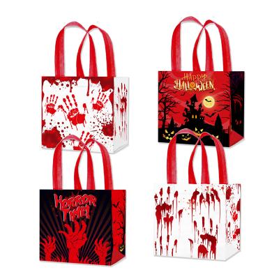 China Xindeli WFF007 Recyclable Non-woven Bags Halloween Hand Print Candy Bloody Candy Bags Trick or Treat Tote Gift Bags for Halloween Party for sale