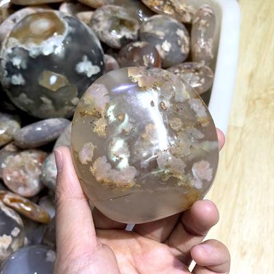 China China Natural Cherry Blossom Agate Palmstone 5-7cm Crystal Palm Tumbled Polished Stone for sale