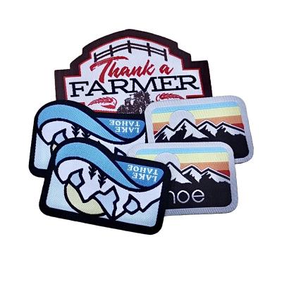 China Viable Bulk Custom Made Pattern Logo Machine Hat Woven Patches with Merrow Border for sale