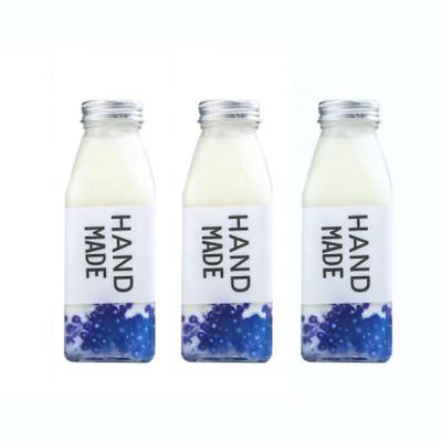 China Wholesale Glass Juice Bottles French Square Bottles From China Supplier Environmentally Friendly With Plastic Or Metal Lid for sale