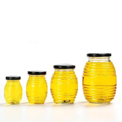 China Custom Eco-freindly 100ml 250ml 500ml 750ml Round Bee Shaped Glass Honey Jar With Metal Lid for sale