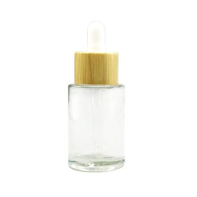 China Cosmetic Cylinder Essential Oil bottle Glass Dropper Bottle Cosmetic Serum bottle with Bamboo Dropper for sale